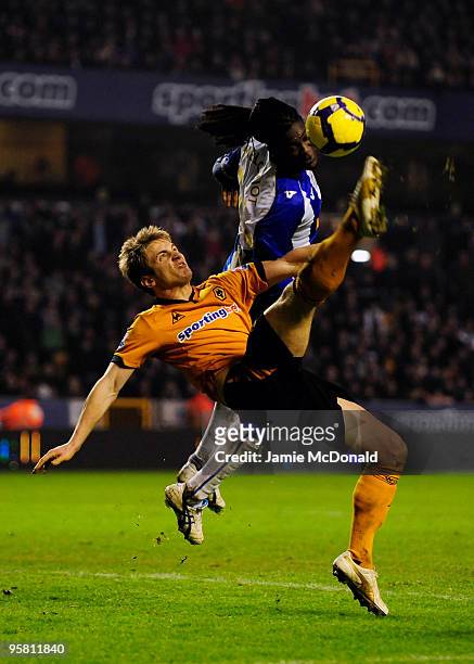 Kevin Doyle of Wolves battles with Mario Melchiot of Wigan during the Barclays Premier League match between Wolverhampton Wanderers and Wigan...