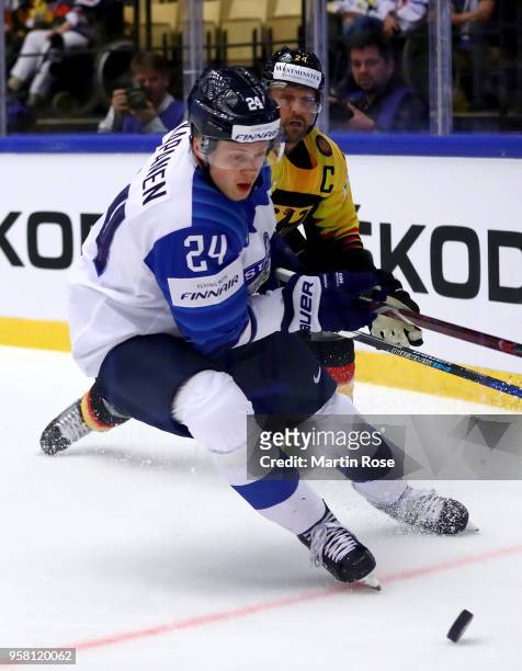 Dennis Seidenberg of Germany and Kasperi Kapanen of Finland battle for the puck during the 2018 IIHF Ice Hockey World Championship Group B game...