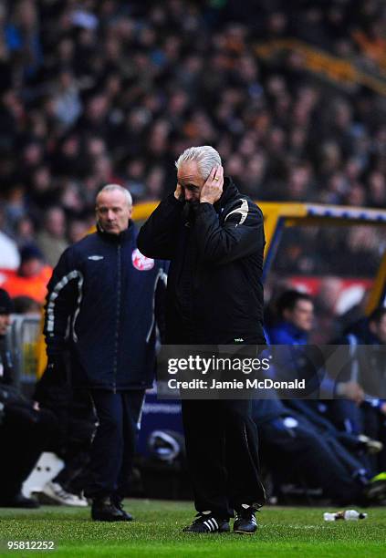 Manager of Wolves Mick McCarthy cannot bear to watch during the Barclays Premier League match between Wolverhampton Wanderers and Wigan Athletic at...