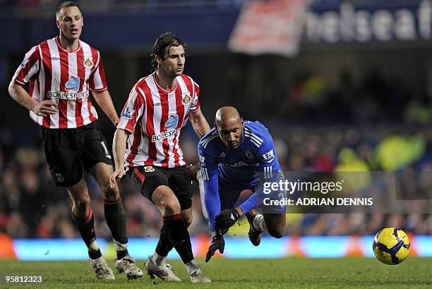 Chelsea's French striker Nicolas Anelka is tackled by Sunderland's Albanian player Lorik Cana during the English Premier League football match...