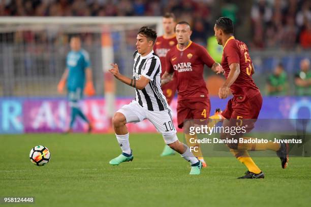 Paulo Dybala of Juventus competes for the ball with Radja Nainggolan and Nunes Juan Jesus of AS Roma during the serie A match between AS Roma and...