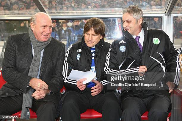 Manager Dieter Hoeness of Wolfsburg, assistant coach Alfons Higl and head coach Armin Veh of Wolfsburg sit on the bench during the Bundesliga match...