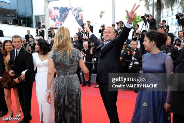 Belgian actor Benoit Poelvoorde gestures as he arrives with French actress Marina Fois, French actor Guillaume Canet, French actress Leila Bekhti,...