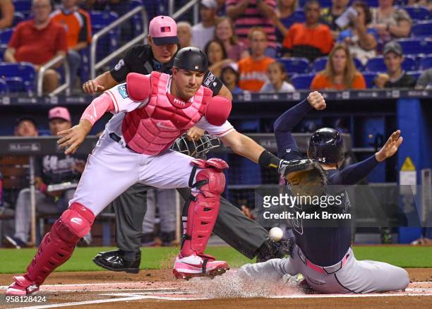 Freddie Freeman of the Atlanta Braves slides into home plate for the score in the first inning against the Miami Marlins at Marlins Park on May 13,...