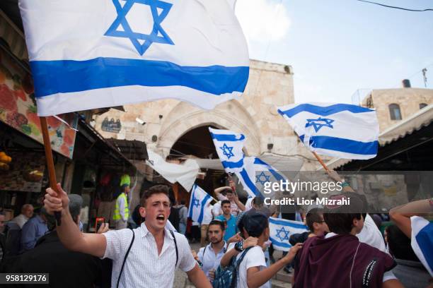 Israelis wave their national flags during a march inside Damascus Gate on May 13, 2018 in Jerusalem, Israel. Israel mark Jerusalem Day celebrations...