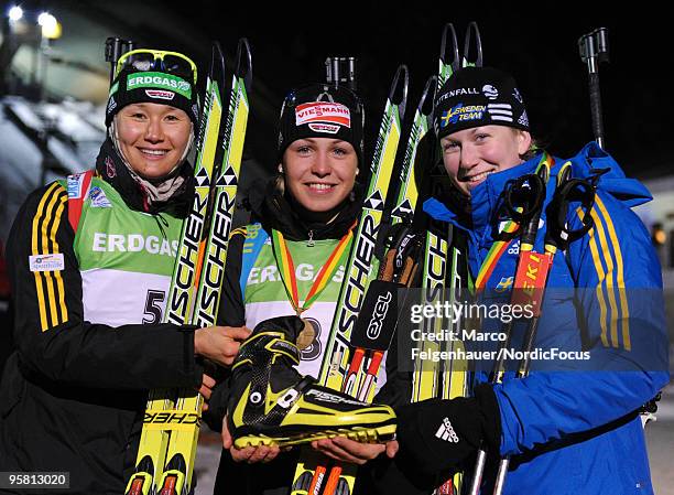 Simone Hauswald of Germany, Magdalena Neuner of Germany and Helena Jonsson of Sweden pose after the women's mass start in the e.on Ruhrgas IBU...