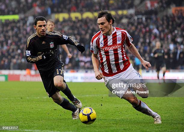 Maxi Rodriguez of Liverpool competes with Dean Whitehead of Stoke during the Barclays Premier League match between Stoke City and Liverpool at...