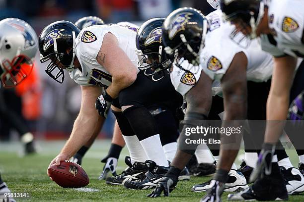 Matt Birk of the Baltimore Ravens centers the ball against the New England Patriots during the 2010 AFC wild-card playoff game at Gillette Stadium on...