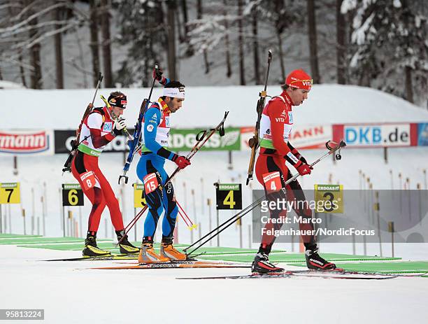 Dominik Landertinger of Austria, Martin Fourcade of France and Emil Hegle Svendsen of Norway compete during the men's mass start in the e.on Ruhrgas...