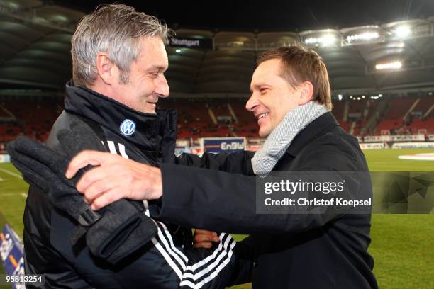 Manager Horst Heldt of Stuttgart welcomes head coach Armin Veh of Wolfsburg before the Bundesliga match between VfB Stuttgart and VfL Wolfsburg at...