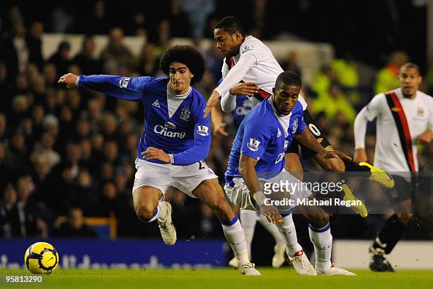Robinho of Manchester City tangles with Marouane Fellaini and Sylvain Distin of Everton during the Barclays Premier League match between Everton and...