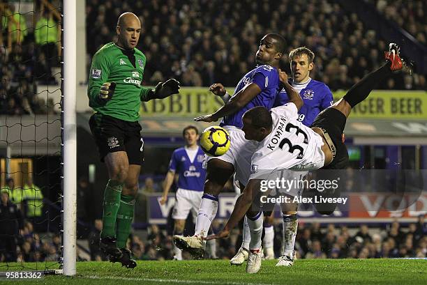 Vincent Kompany of Manchester City is challenged by Sylvain Distin of Everton during the Barclays Premier League match between Everton and Manchester...