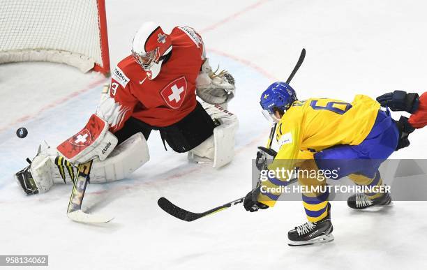 Switzerland's Leonardo Genoni vies with Sweden's Rickard Rakell during the group A match Switzerland vs Sweden of the 2018 IIHF Ice Hockey World...