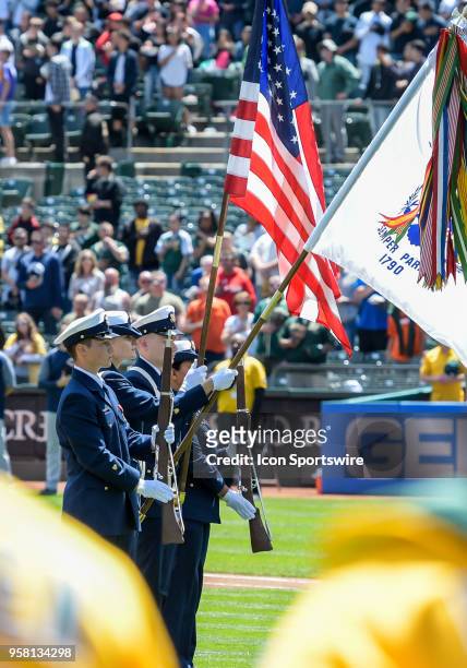 Military color guards present the colors during pregame ceremonies at the game between the Houston Astros vs Oakland Athletics on Wednesday, May 9,...