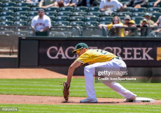 Oakland Athletics First base Matt Olson reaches for the ball for the out at first during the game between the Houston Astros vs Oakland Athletics on...