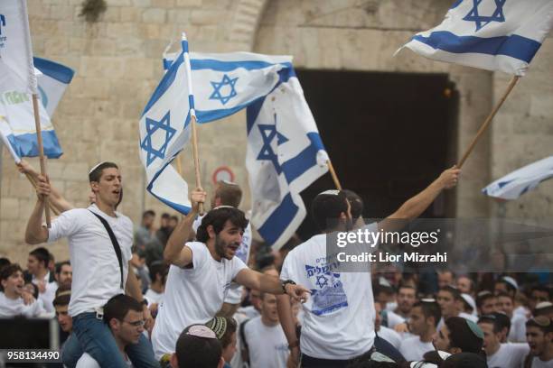 Israelis wave their national flags during a march outside Damascus Gate on May 13, 2018 in Jerusalem, Israel. Israel mark Jerusalem Day celebrations...