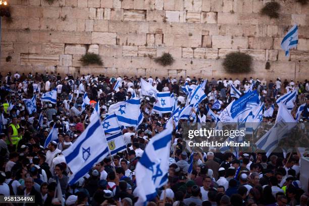 Israelis wave their national flags during a march at the Western Wall on May 13, 2018 in Jerusalem, Israel. Israel mark Jerusalem Day celebrations...