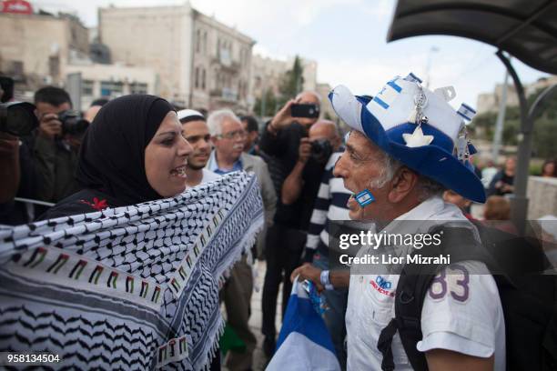 An Israeli man argues with a Palestinian woman before Aa flags march outside Damascus Gate on May 13, 2018 in Jerusalem, Israel. Israel mark...