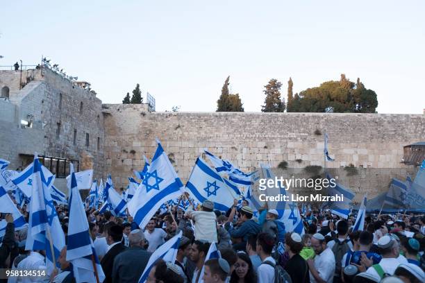 Israelis wave their national flags during a march at the Western Wall on May 13, 2018 in Jerusalem, Israel. Israel mark Jerusalem Day celebrations...