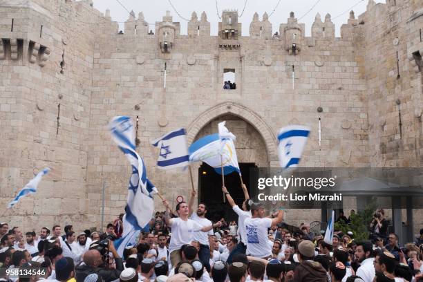 Israelis wave their national flags during a march outside Damascus Gate on May 13, 2018 in Jerusalem, Israel. Israel mark Jerusalem Day celebrations...