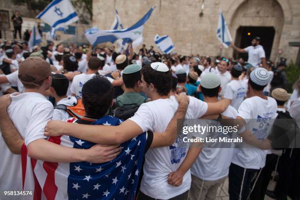 Man wearing an American flag dance during a flags march outside Damascus Gate on May 13, 2018 in Jerusalem, Israel. Israel mark Jerusalem Day...