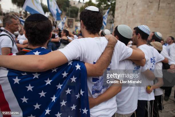 Man wearing an American flag dance during a flags march outside Damascus Gate on May 13, 2018 in Jerusalem, Israel. Israel mark Jerusalem Day...