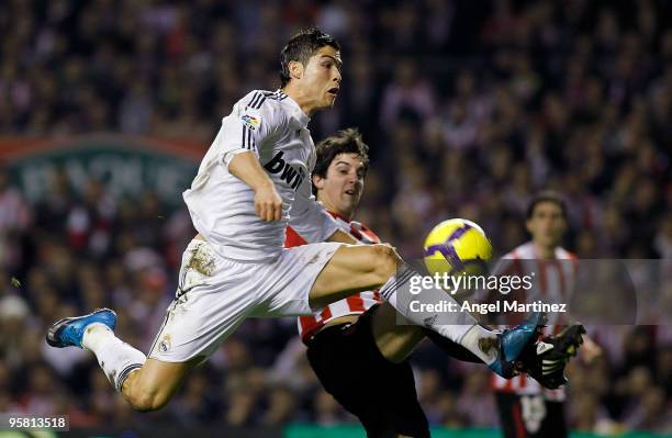 Cristiano Ronaldo of Real Madrid controls the ball beside Mikel San Jose of Athletic Bilbao during the La Liga match between Athletic Bilbao and Real...