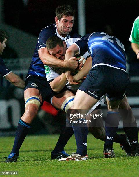 Brive's Shaun Perry is tackled by Leinster's Stan Wright and Sean O'Brien during round 5 of the European Cup match at the Royal Dublin Society...