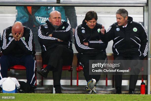 Manager Dieter Hoeness , assistant coach Alfons Higl and head coach Armin Veh of Wolfsburg show their frustration during the Bundesliga match between...