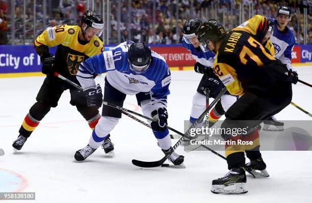 Patrick Hager of Germany and Miro Heiskanen of Finland battle for the puck during the 2018 IIHF Ice Hockey World Championship Group B game between...