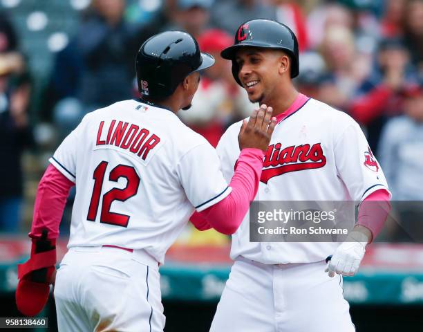 Michael Brantley of the Cleveland Indians celebrates with Francisco Lindor after hitting a two run home run off Brian Flynn of the Kansas City Royals...