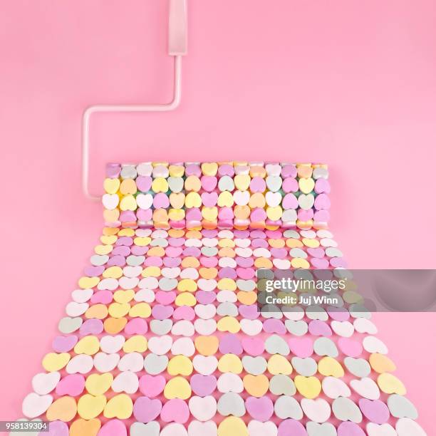 paint roller with candy hearts - valentines candy heart stock pictures, royalty-free photos & images