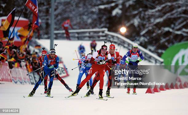 Dominik Landertinger of Austria, Simon Fourcade of France and Alexander Os of Norway compete during the men's mass in the e.on Ruhrgas IBU Biathlon...