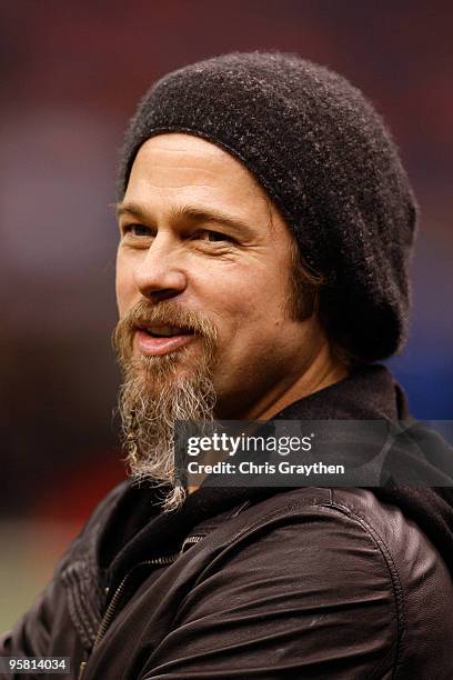 Actor Brad Pitt stands on the sidelines during warm ups prior to the New Orleans Saints hosting the Arizona Cardinals during the NFC Divisional...