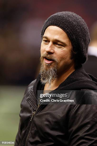 Actor Brad Pitt stands on the sidelines during warm ups prior to the New Orleans Saints hosting the Arizona Cardinals during the NFC Divisional...