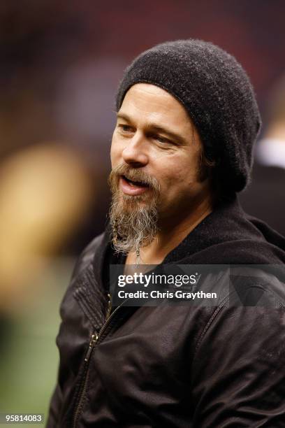 Actor Brad Pitt stands on the sidelines during warm ups prior to the New Orleans Saints hosting the Arizona Cardinals during the NFC Divisional...