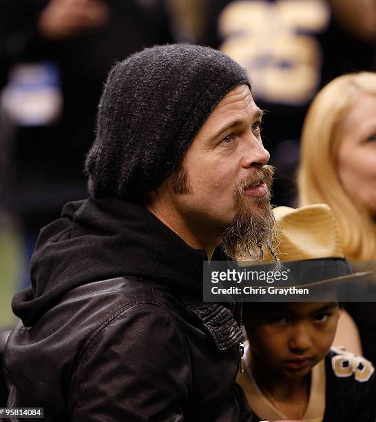Actor Brad Pitt and his son Maddox Jolie-Pitt sit on the bench on the sidelines during warm ups prior to the New Orleans Saints hosting the Arizona...