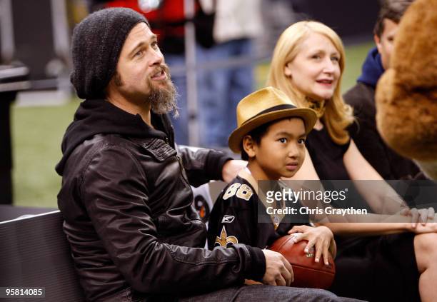 Actor Brad Pitt, his son Maddox Jolie-Pitt and actress Patricia Clarkson sit on the bench on the sidelines during warm ups prior to the New Orleans...