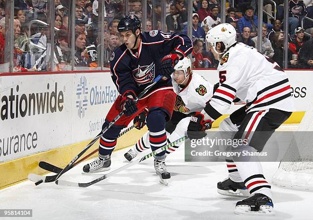 Jared Boll of the Columbus Blue Jackets battles for the puck with Brent Sopel of the Chicago Blackhawks on January 16, 2010 at Nationwide Arena in...