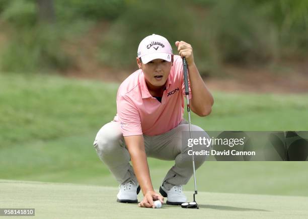 Danny Lee of New Zealand lines up a putt on the par 5, second hole during the final round of the THE PLAYERS Championship on the Stadium Course at...