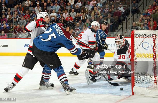 Chris Stewart of the Colorado Avalanche beats the defense of Mike Mottau of the New Jersey Devils and puts the puck past goaltender Martin Brodeur of...