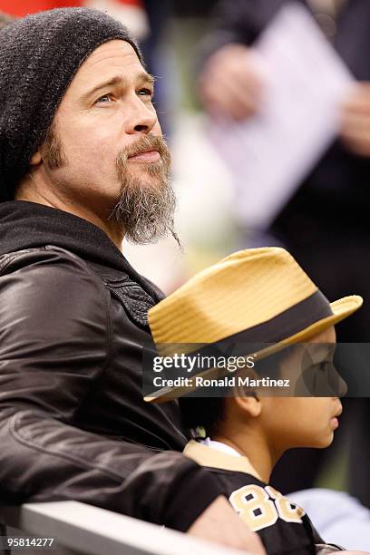 Actor Brad Pitt and his son Maddox Jolie-Pitt sit on the bench on the sidelines during warm ups prior to the New Orleans Saints hosting the Arizona...