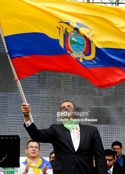 President of Ecuador Rafael Correa raises Ecuadorian flag during a gathering to celebrate three years of government on January 16, 2010 in Quito,...