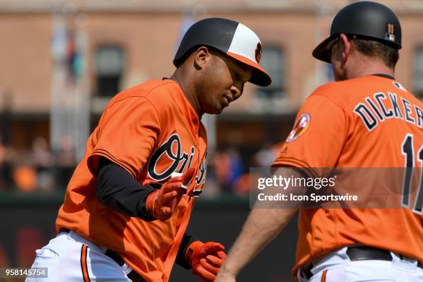 Baltimore Orioles second baseman Jonathan Schoop is congratulated by third base coach Bobby Dickerson after hitting a second inning home run during...