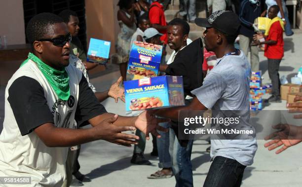 Water, food and hygiene supplies are delivered to the Hospital Espoire by the humanitarian group Save the Children January 16, 2010 in...