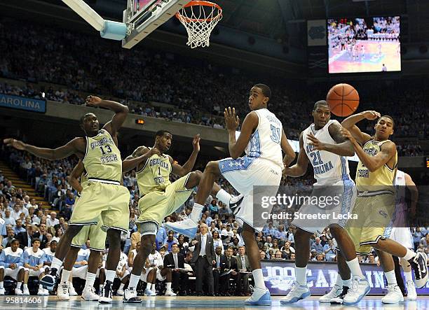 The defense of the Georgia Tech Yellow Jackets stops John Henson of the North Carolina Tar Heels during their game at the Dean Smith Center on...