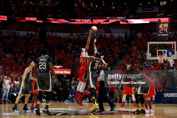 Anthony Davis of the New Orleans Pelicans tips off Kevin Durant of the Golden State Warriors during Game Four of the Western Conference Semifinals of...