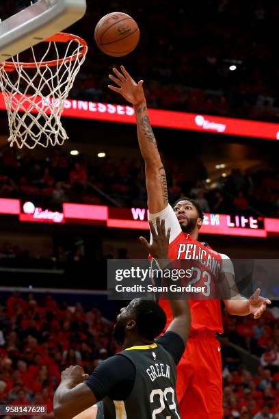 Anthony Davis of the New Orleans Pelicans shoot over Draymond Green during Game Four of the Western Conference Semifinals of the 2018 NBA Playoffs at...