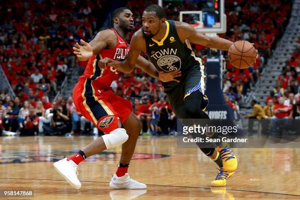 Kevin Durant of the Golden State Warriors is defended by E'Twaun Moore of the New Orleans Pelicans during Game Four of the Western Conference...
