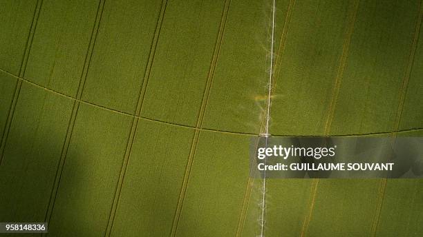 An aerial picture taken on May 13, 2018 shows an automatic watering system in a field near Sublaines.